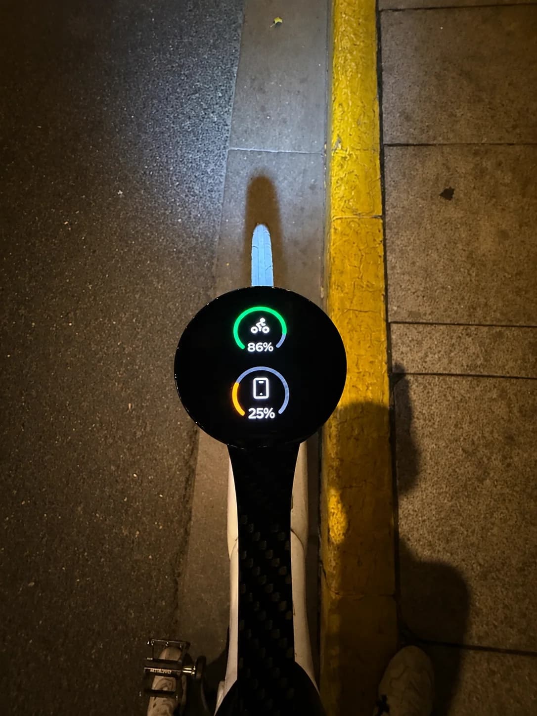 Bicino showing bike computer and phone battery levels while mounted on a bike at night