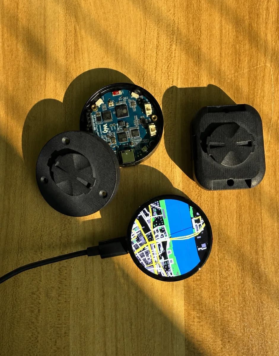 bicino one prototype display, circuit board, case, and two Garmin-compatible mounts laid out in sunlight